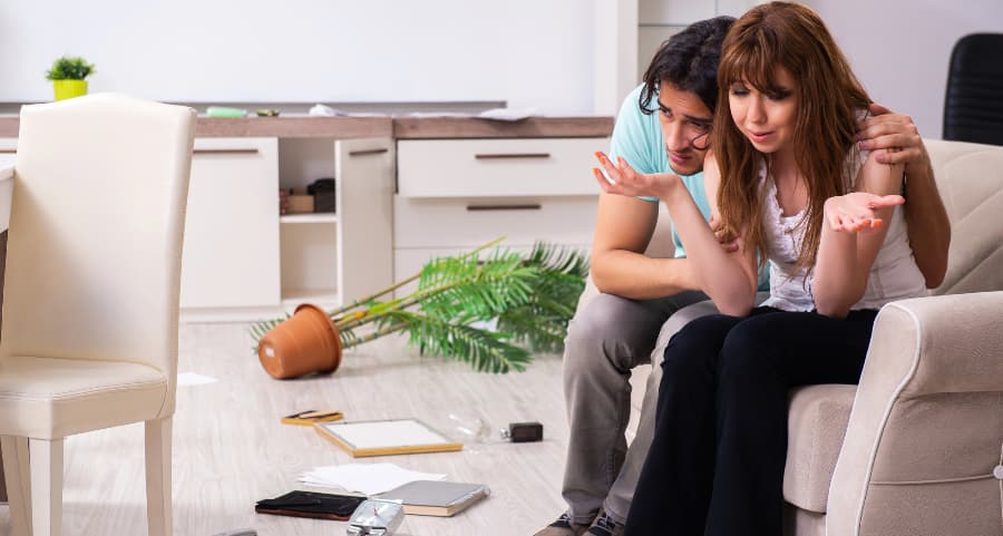 Couple assessing damage after a burglary